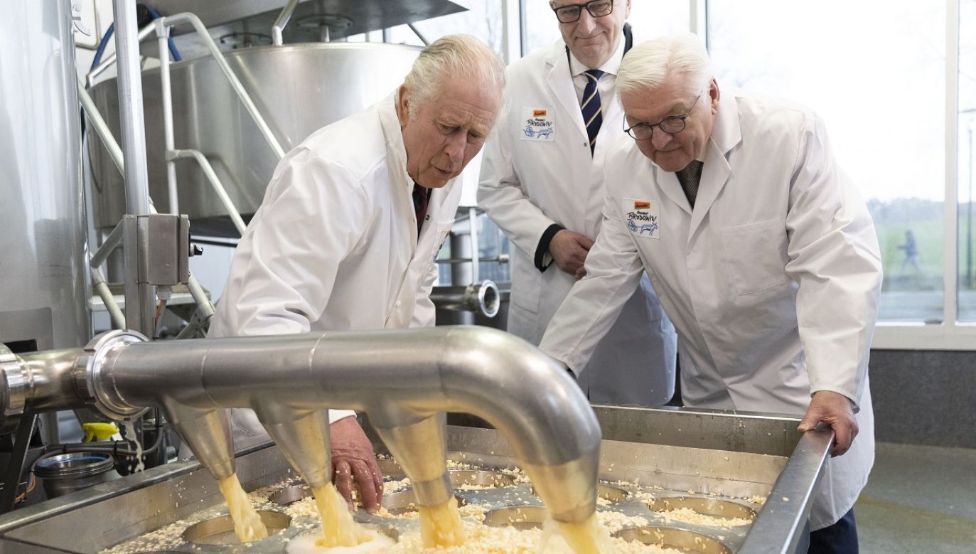 King Charles III helps with the production of cheese during a visit to an organic farm on day two of his state visit to Germany. March 30, 2023 in Brandenburg, Germany. Photo: Stephen Lock - Pool/Getty Images